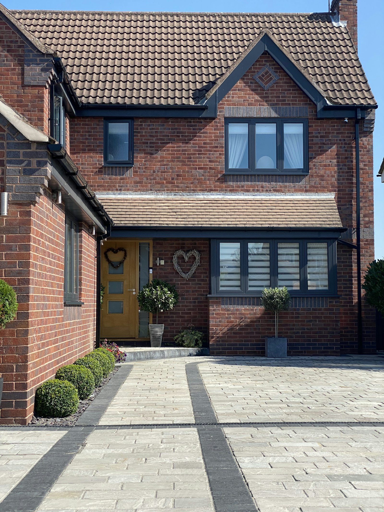 Brick front extension and porch on a detached house